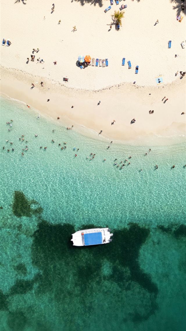 1290x2796 an aerial view of a beach with a boat in the water -  iPhone Wallpaper