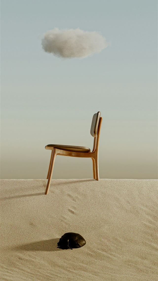 1290x2796 a chair sitting on top of a sandy hill -  iPhone Wallpaper