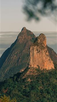 brown rock formation under white clouds during day... wallpaper