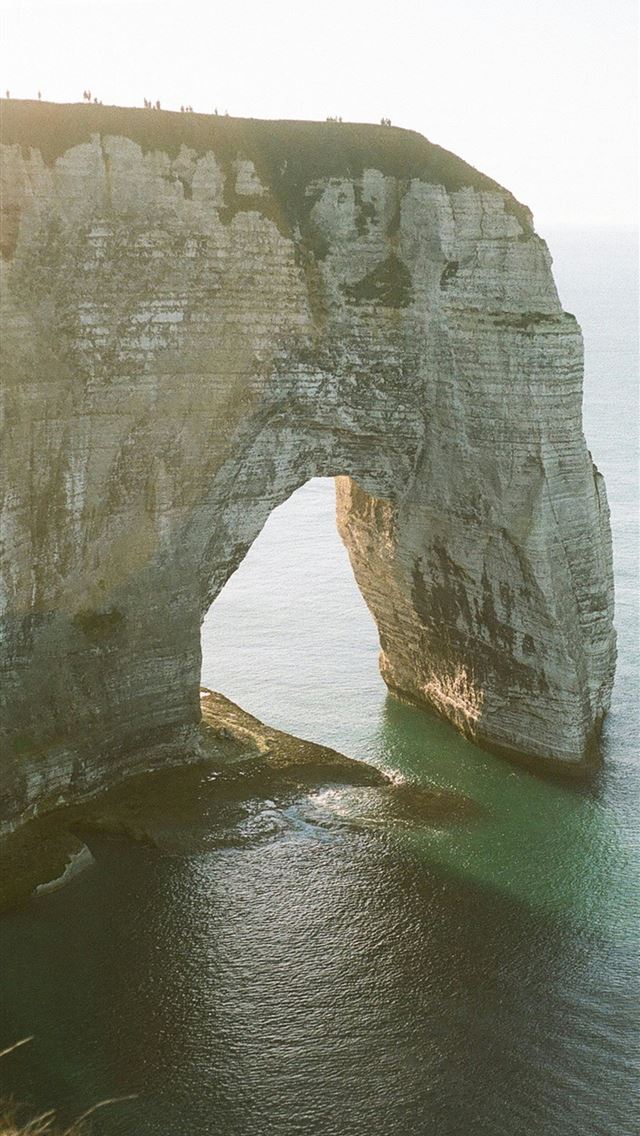 640x1136 a large rock formation in the middle of a body of ... -  iPhone Wallpaper