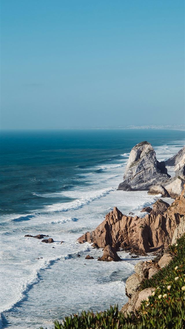 1290x2796 a view of the ocean from the top of a hill -  iPhone Wallpaper