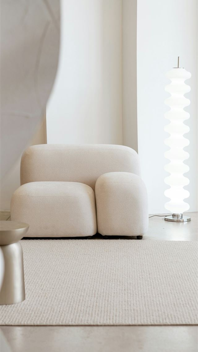 1290x2796 a white couch sitting in a room next to a window -  iPhone Wallpaper
