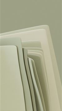 a close up of a stack of folded papers wallpaper