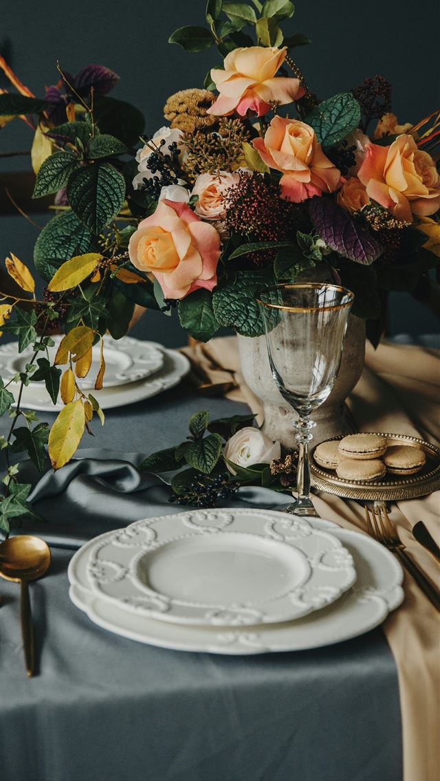 1290x2796 a table topped with a vase filled with flowers -  iPhone Wallpaper