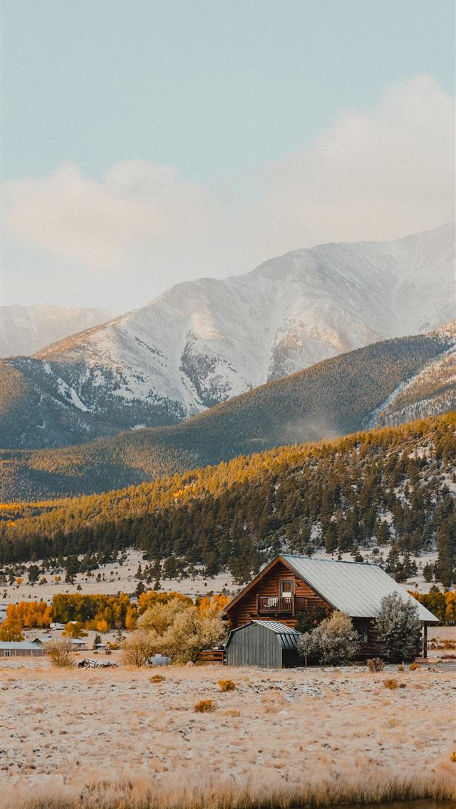 1290x2796 a small cabin in the middle of a field with mounta... -  iPhone Wallpaper