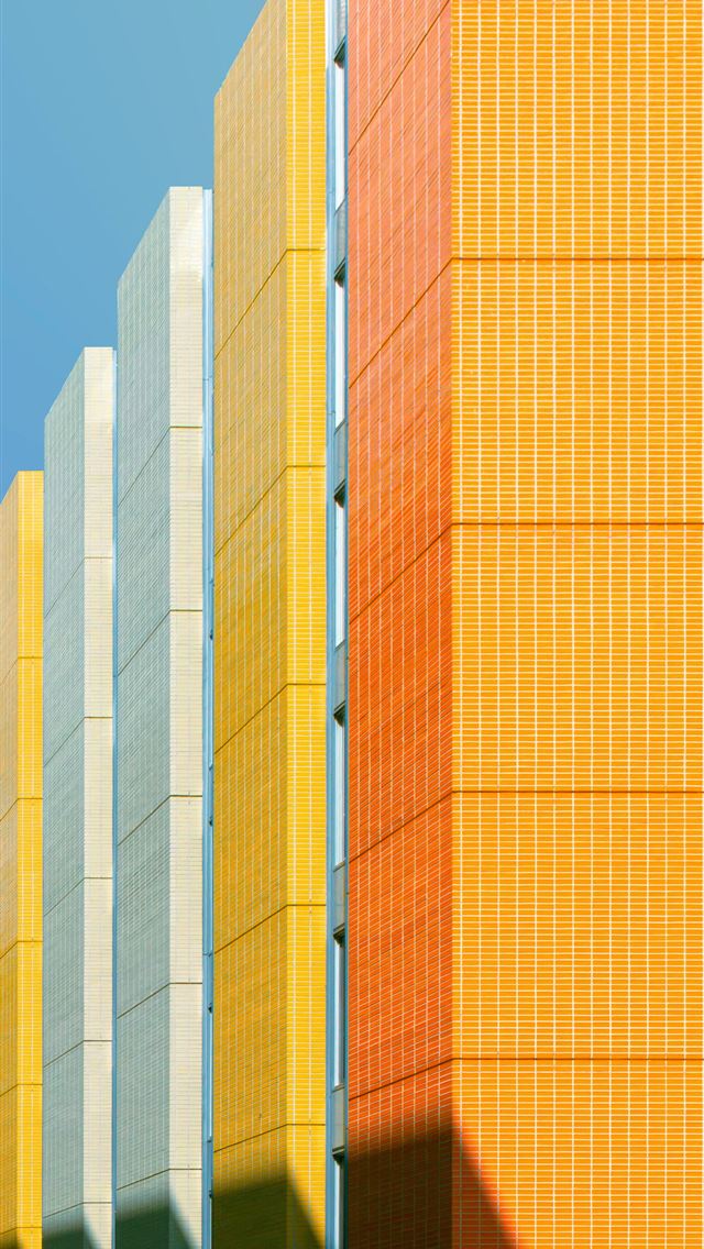 1290x2796 a row of yellow and grey buildings against a blue ... -  iPhone Wallpaper