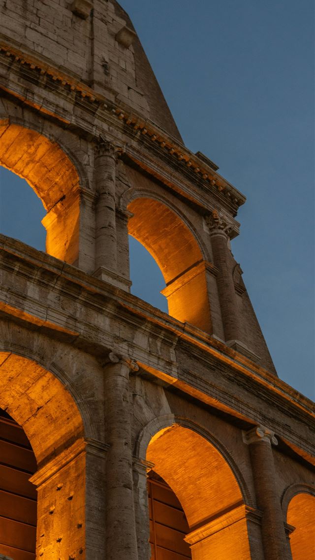 1290x2796 a very tall building with a clock on it's side -  iPhone Wallpaper