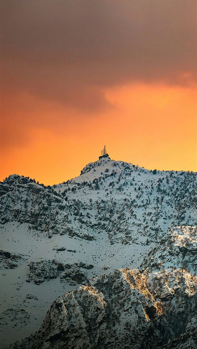 1290x2796 a snow covered mountain under a cloudy sky - winter iPhone Wallpaper