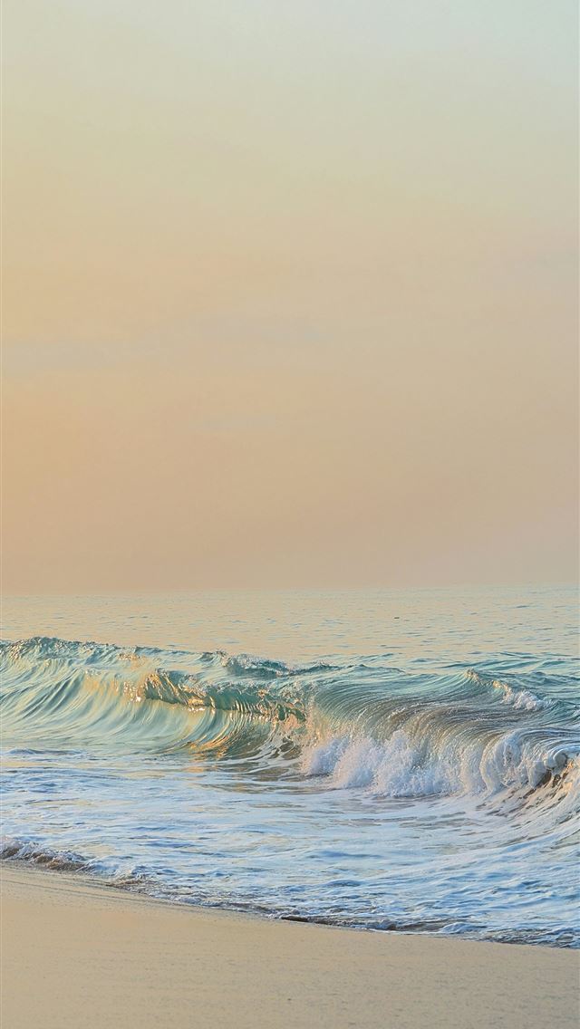 1290x2796 a person riding a surfboard on top of a sandy beac... -  iPhone Wallpaper