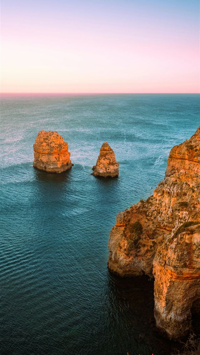 1290x2796 a body of water with some rocks in the middle of i... -  iPhone Wallpaper