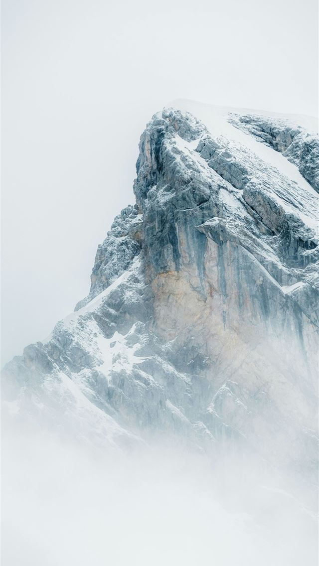 1290x2796 a large mountain covered in snow and clouds -  iPhone Wallpaper