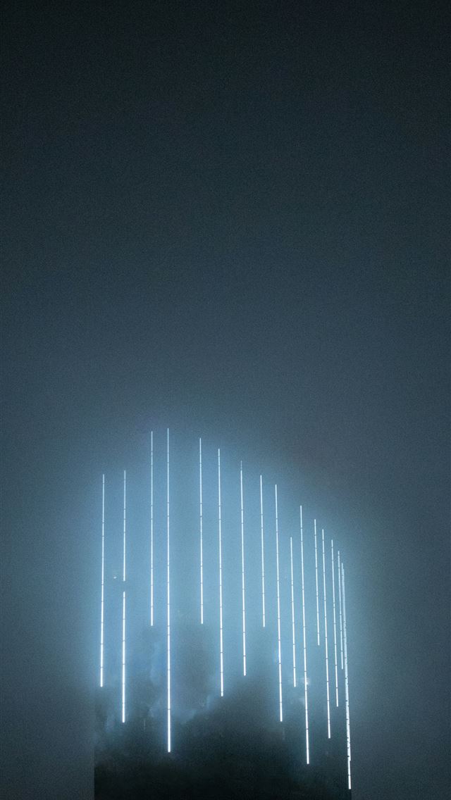 1290x2796 a tall building with a lot of lights on it -  iPhone Wallpaper