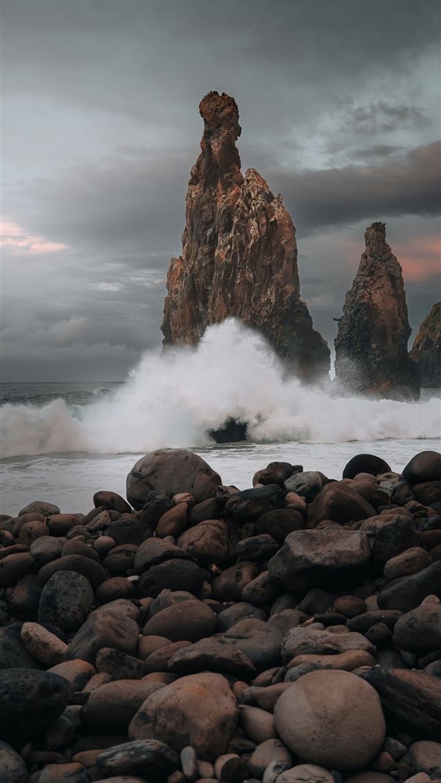 1290x2796 Waves crash against rocky sea stacks under cloudy ... -  iPhone Wallpaper