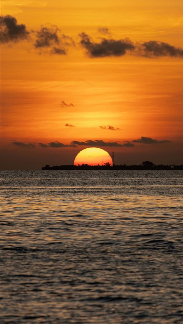 1290x2796 the sun is setting over the ocean with a small isl... - sunset iPhone Wallpaper