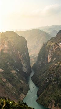 a river in a valley surrounded by mountains wallpaper