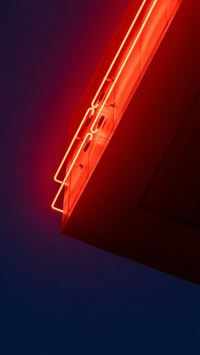 Bright red neon sign against dark blue background wallpaper