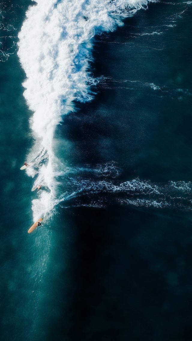 1290x2796 a person riding a surfboard on a wave in the ocean -  iPhone Wallpaper