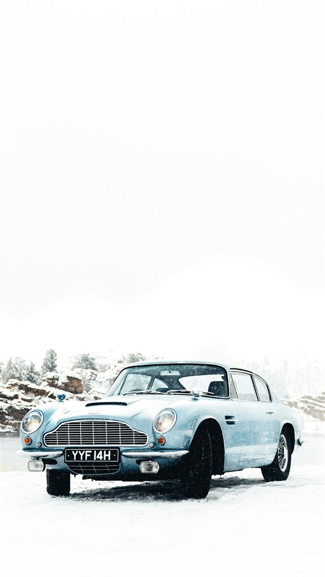 1290x2796 a blue car is parked in the snow - adventure iPhone Wallpaper