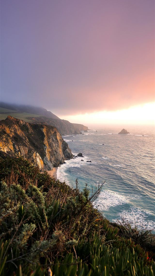 1290x2796 green grass on brown rocky mountain beside blue se... -  iPhone Wallpaper