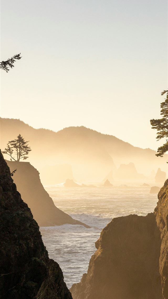 1290x2796 a person standing on a cliff overlooking the ocean - sea iPhone Wallpaper