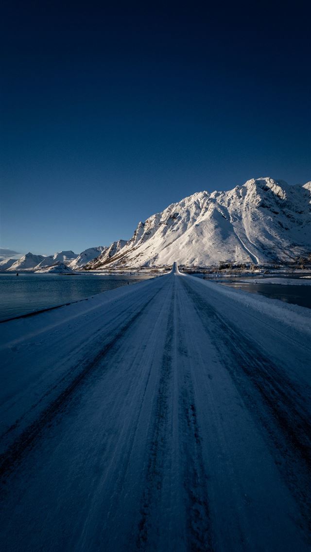 1290x2796 a snow covered road with a mountain in the backgro... -  iPhone Wallpaper