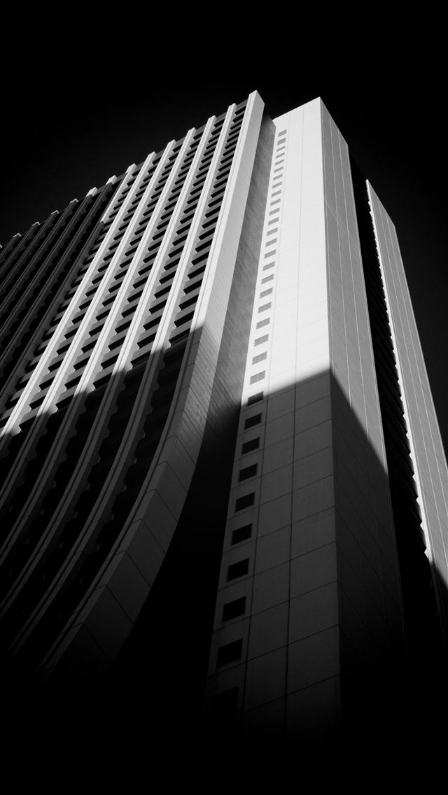 1290x2796 A black and white photo of a tall building  - golden hour iPhone Wallpaper