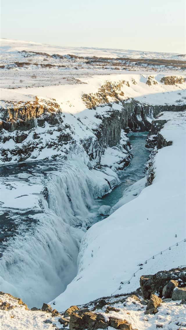 1290x2796 a large waterfall in the middle of a snowy field -  iPhone Wallpaper