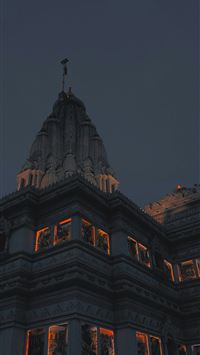 a tall building with a clock on the top of it wallpaper