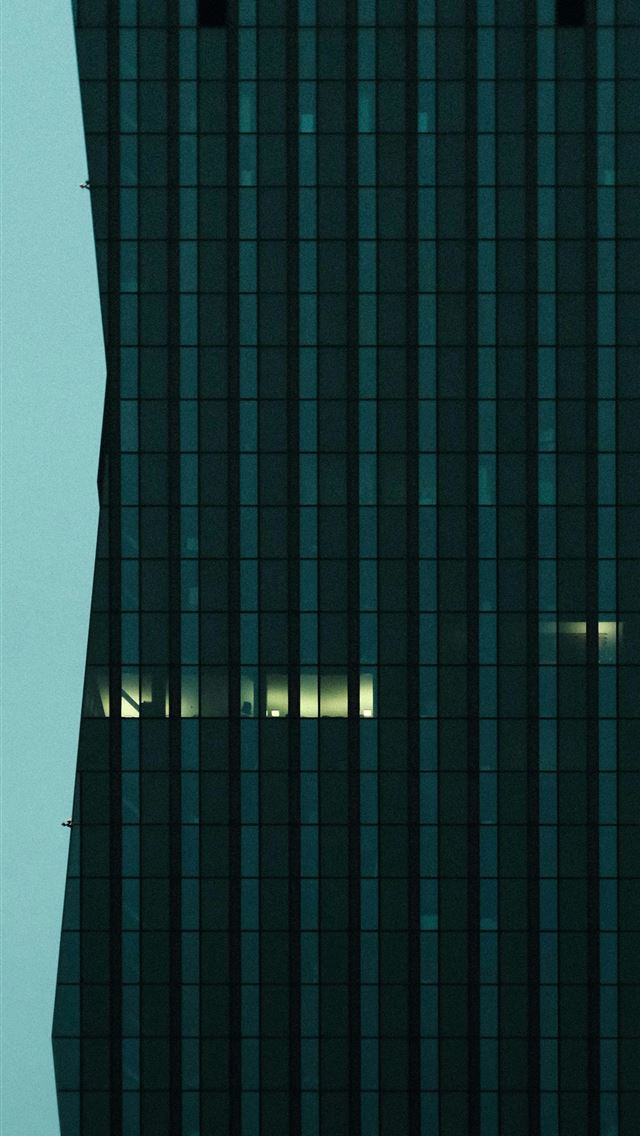 1290x2796 a very tall building with a clock on it's side - minimalist iPhone Wallpaper