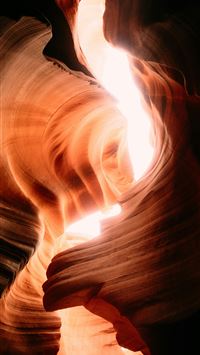 Light streams through a narrow sandstone canyon  wallpaper