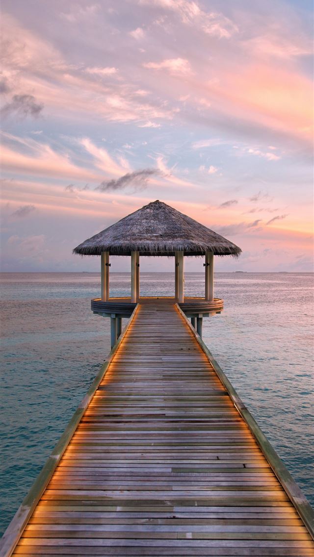 1290x2796 a wooden pier with a hut on top of it - sunrise iPhone Wallpaper