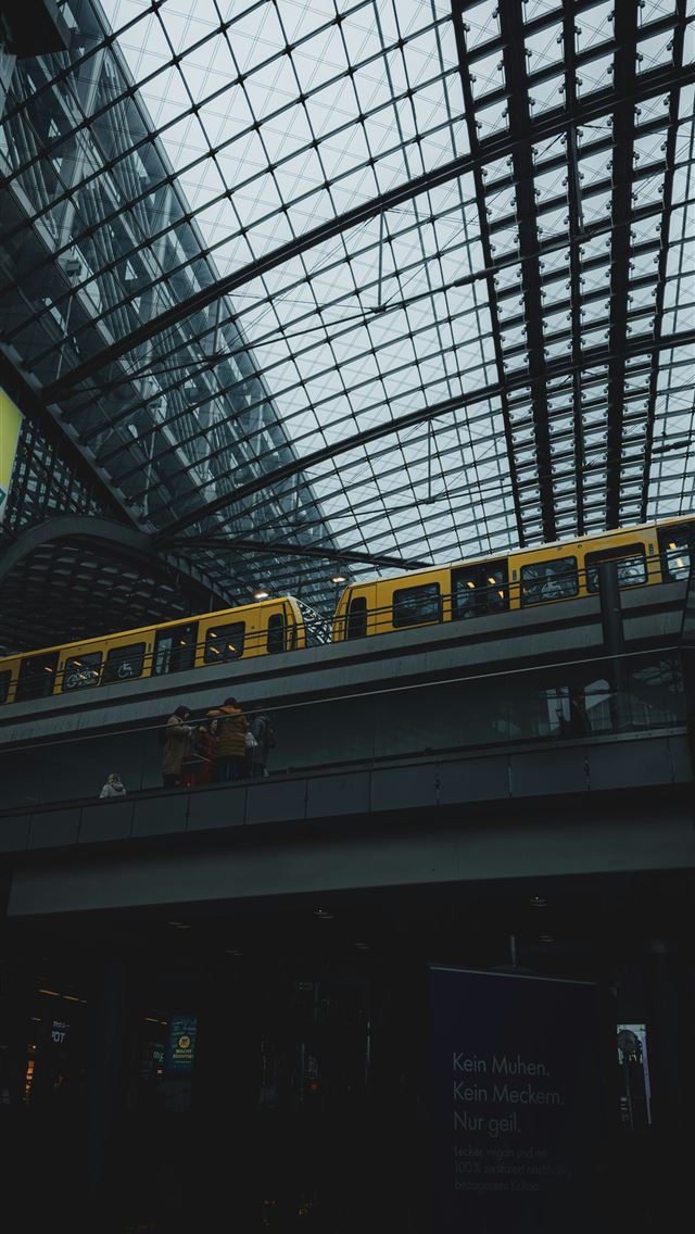 1290x2796 a yellow train traveling through a train station -  iPhone Wallpaper