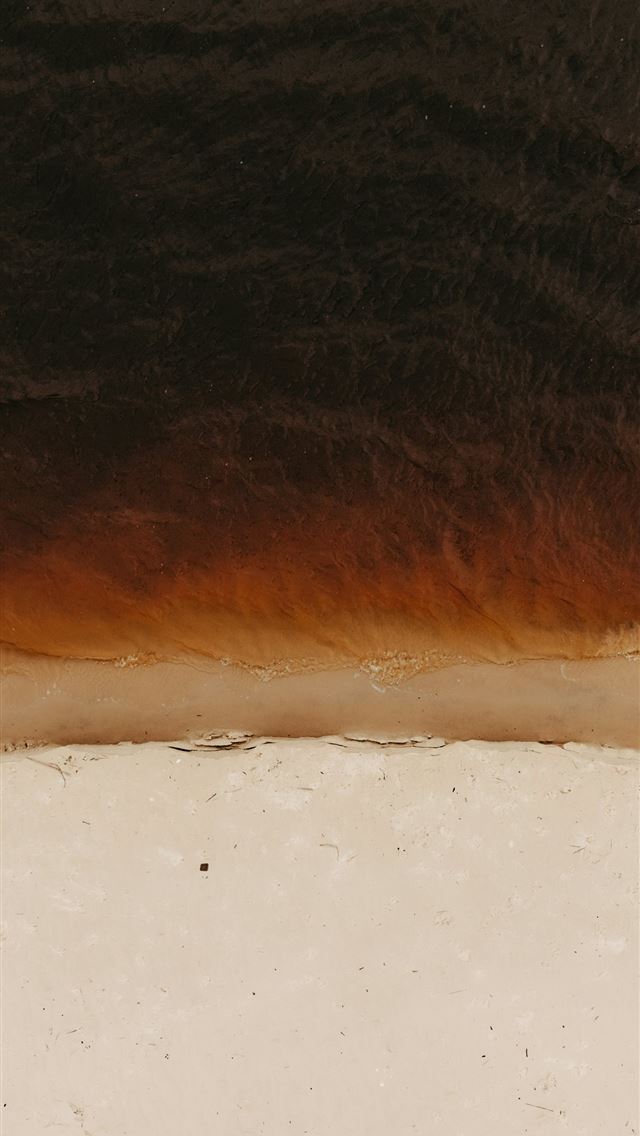 1290x2796 Dark water meets a sandy shore from above -  iPhone Wallpaper