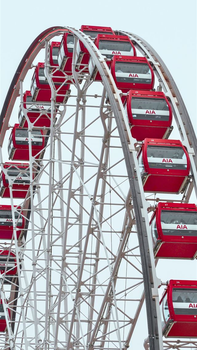 1290x2796 a ferris wheel with red seats on top of it -  iPhone Wallpaper