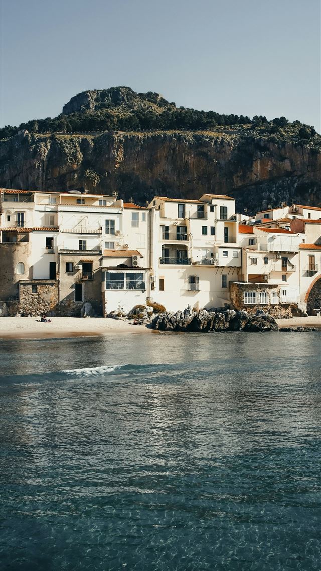 1290x2796 a small town on the shore of a body of water - city iPhone Wallpaper