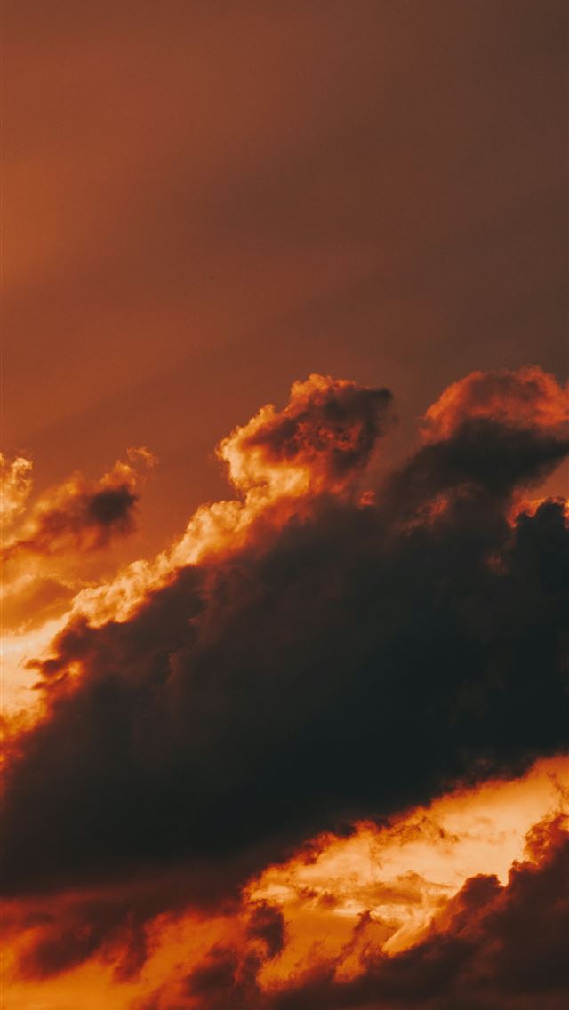 1290x2796 a plane flying through a cloudy sky at sunset - sunset iPhone Wallpaper