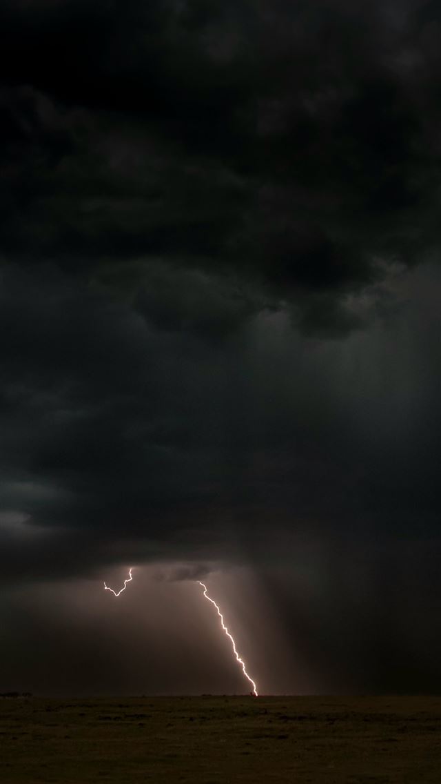 1290x2796 a lightning bolt is seen in the sky above a field -  iPhone Wallpaper