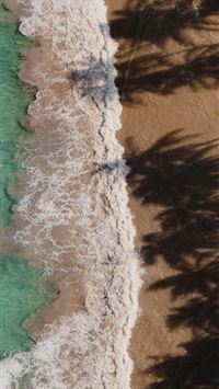 an aerial view of a beach with a body of water wallpaper