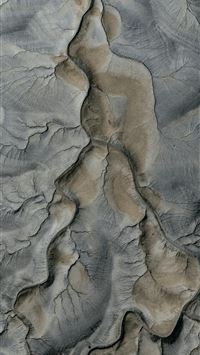 Aerial view of eroded desert landscape with dry ri... wallpaper