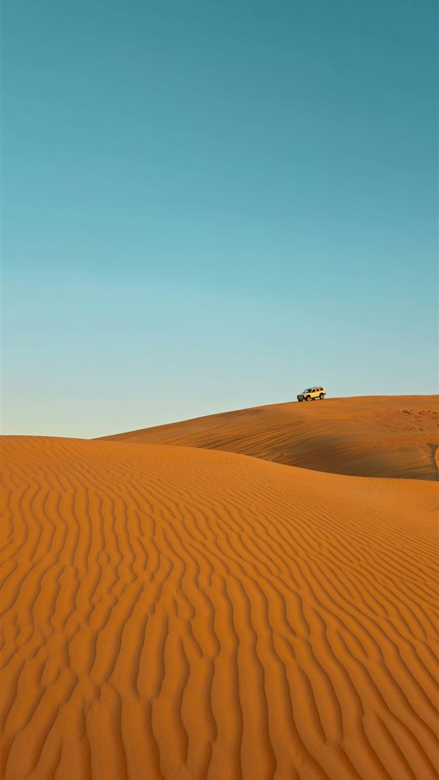 1290x2796 a truck is driving through the desert - sand iPhone Wallpaper