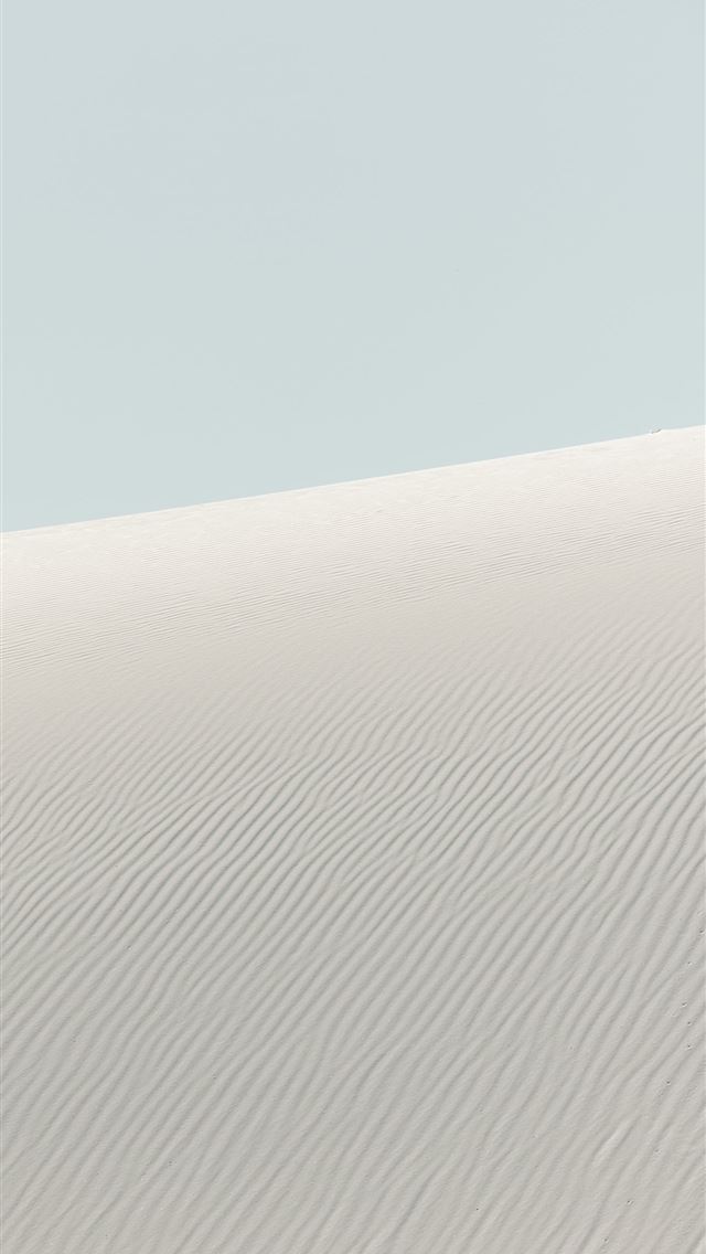 1290x2796 Rippled sand dunes under a pale blue sky -  iPhone Wallpaper