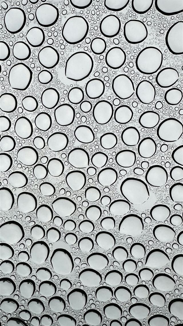 1290x2796 a close up of water droplets on a window -  iPhone Wallpaper