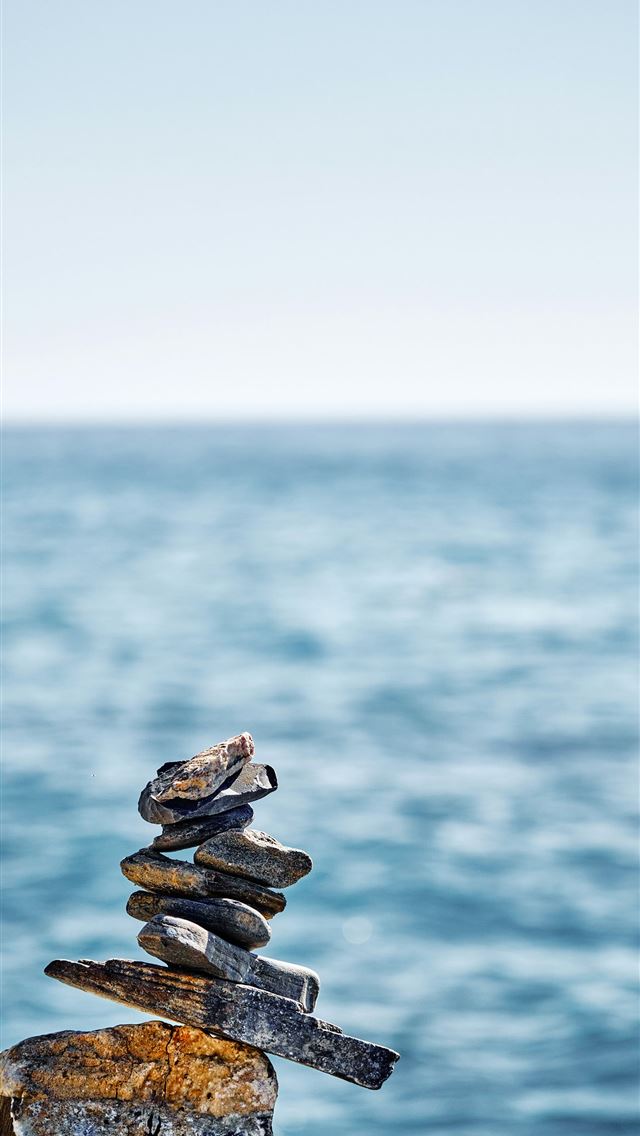 1290x2796 a stack of rocks sitting on top of a rock near the... -  iPhone Wallpaper