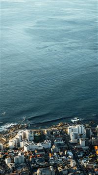 an aerial view of a city by the ocean wallpaper