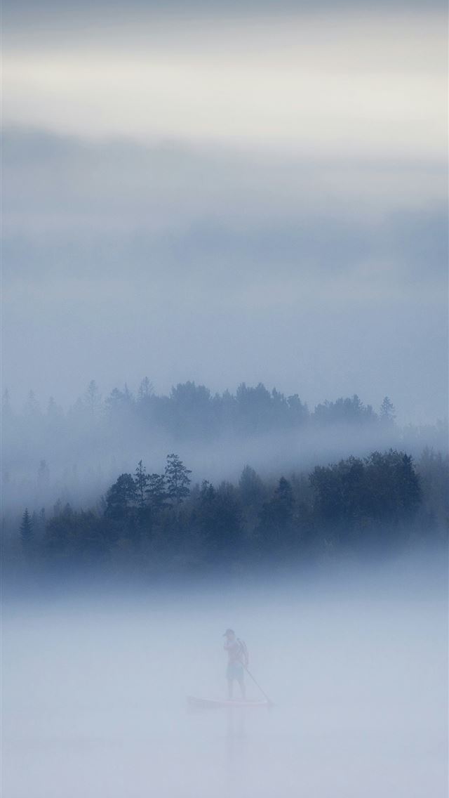 1290x2796 a person standing in the middle of a foggy field -  iPhone Wallpaper