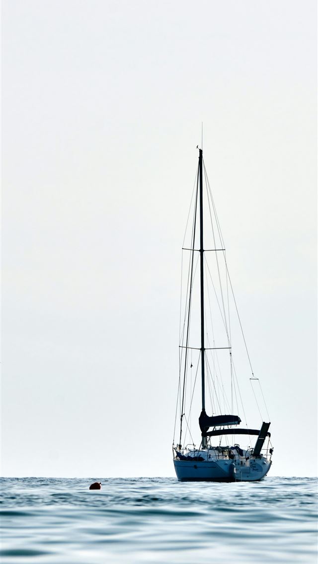 1290x2796 a sailboat floating on top of a body of water - minimal iPhone Wallpaper
