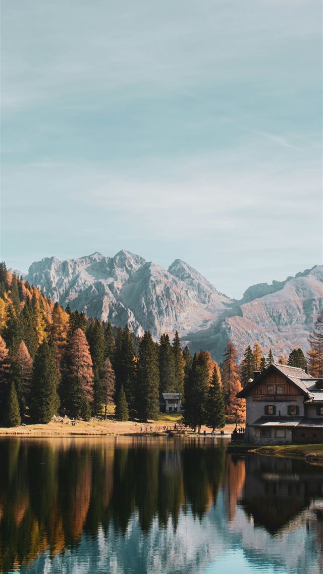 1290x2796 a house by a lake with mountains in the background -  iPhone Wallpaper