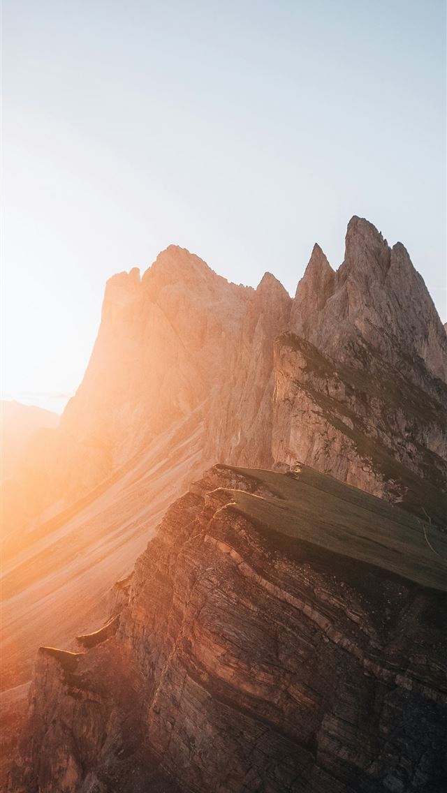1290x2796 the sun is setting on a mountain range -  iPhone Wallpaper