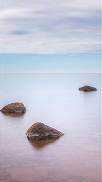 a group of rocks in the water wallpaper
