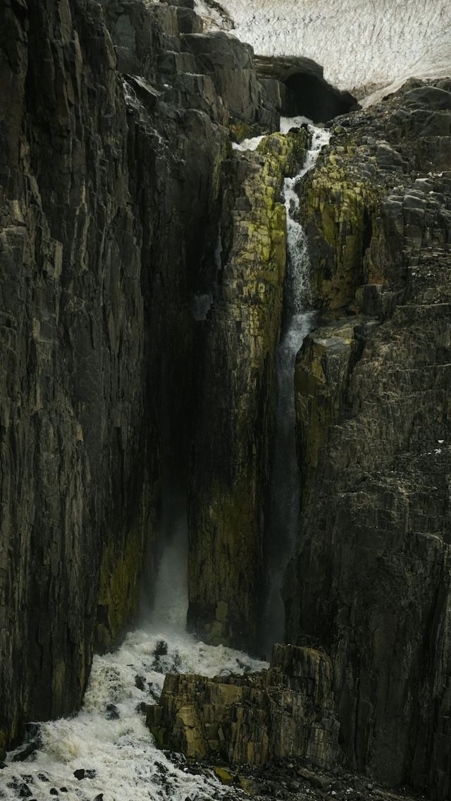 1290x2796 a waterfall in the middle of a rocky cliff -  iPhone Wallpaper